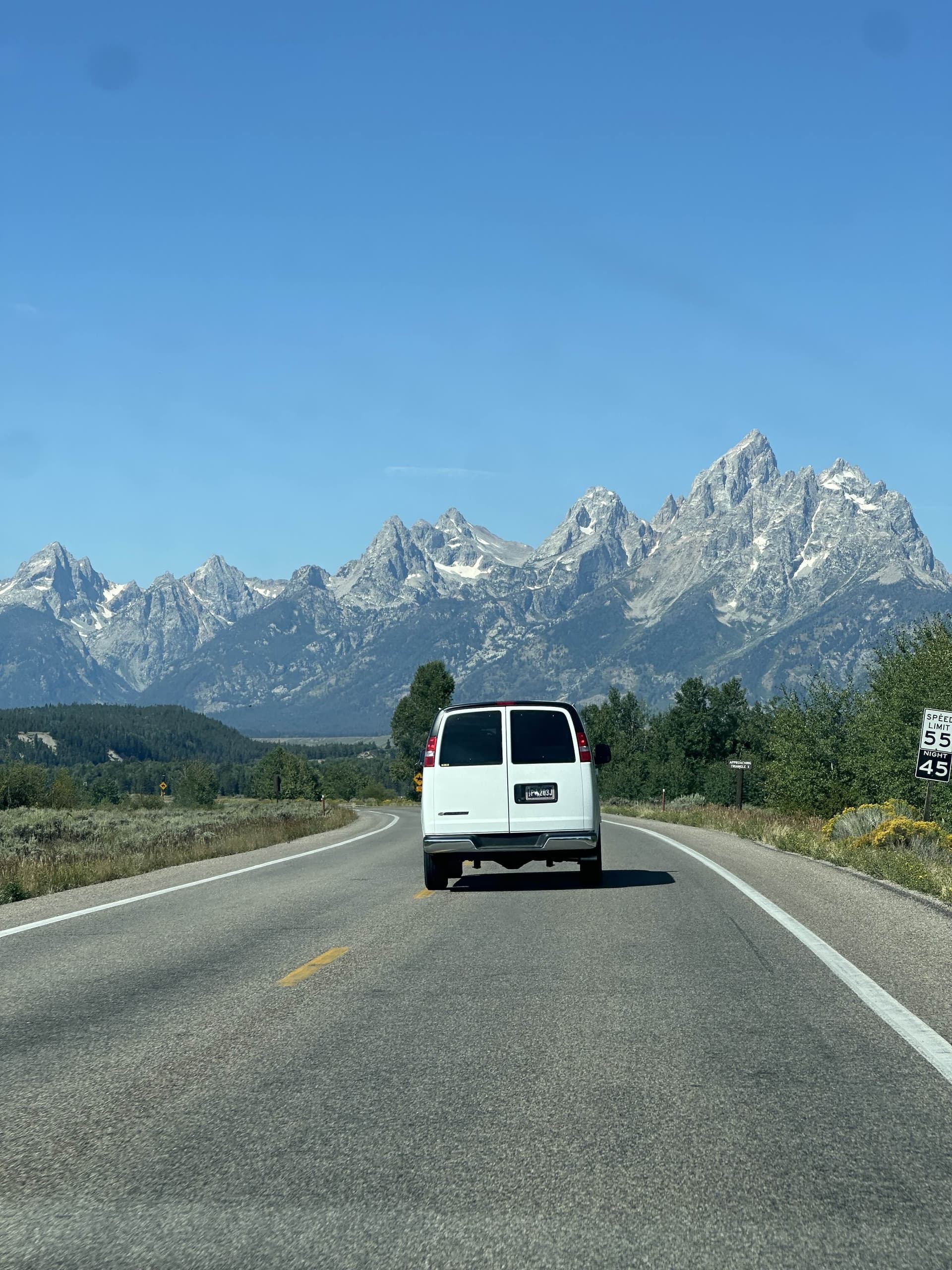 A car with a mountain range in the background